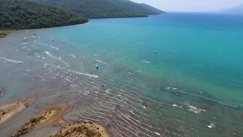 Kiteboarding, Kitesurfing Kiters and Kiteboarders are Pulled Across Sea Water by a Wind Power Kite