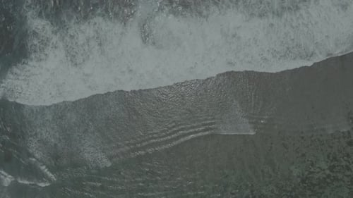 Aerial View of Waves Crashing on Beach