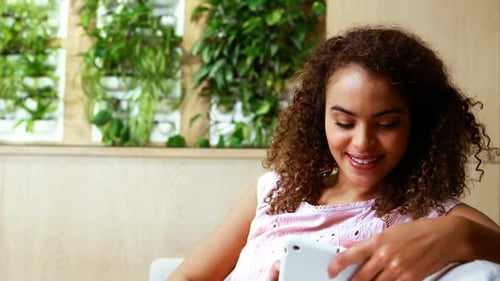 Woman Smiling Using Tablet Indoors