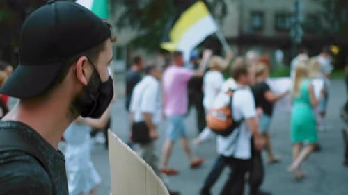 People Marching with Flags in City Protest