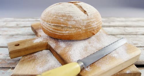 Artisan Bread on Wooden Cutting Boards with Knife