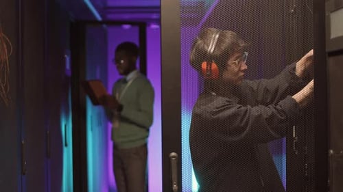 Technicians Work on Servers in Data Center