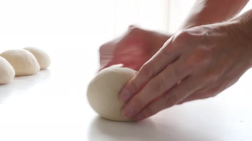 Hand kneaded dough on table by professional 4K 2160p 30fps UltraHD footage - Kneading dough with h