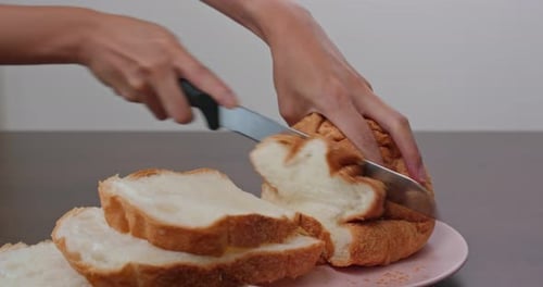 Hands Slicing Delicious White Bread Loaf