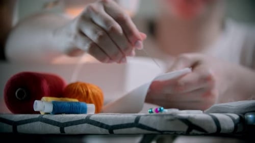 Young Woman Designer Putting Pins in the White Cloth Before Sewing