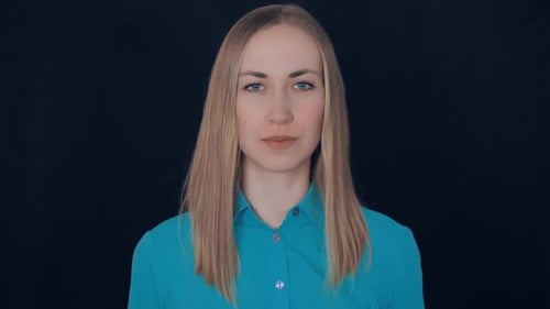 Smiling Woman Makes an Okay Hand Gesture