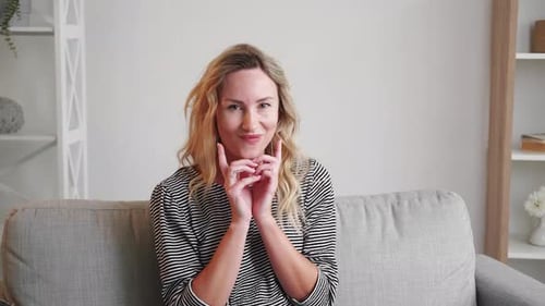 Smiling Woman with Wavy Hair on Couch