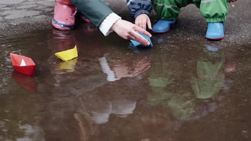 Funny Kid in Rain Boots Playing in a Rain Park