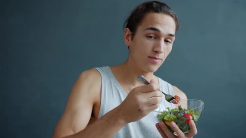 Young Adult Man Eating a Healthy Salad