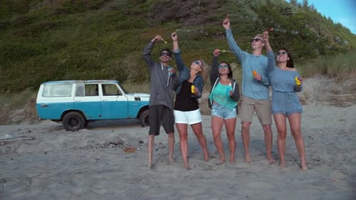 Super slow motion shot of group of friends blowing bubbles at beach, shot with Phantom Flex 4K