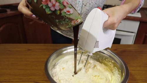 Woman Adding Chocolate to Whipped Cream While Mixing