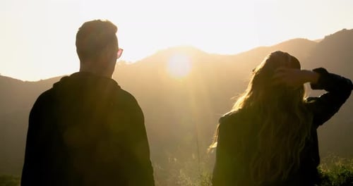 Couple Watching Sunset in Mountains