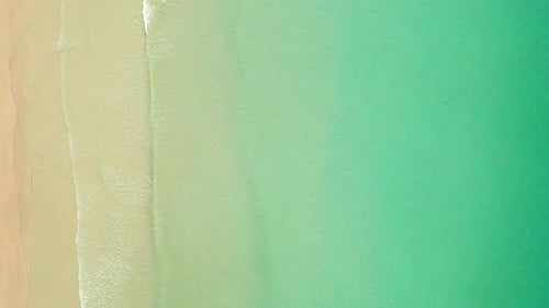 4K Aerial view top view of drone, sea waves and beautiful sand beach.