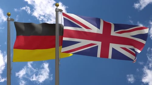 German and UK Flags Waving in a Blue Sky