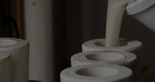 Pouring Clay Into Forms At Pottery Studio