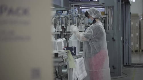 Side View of Professional Employee Packing Finished Products in Factory. Adult Caucasian Woman in