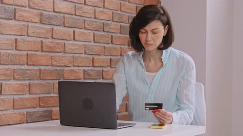 Woman Shopping Online Using Credit Card at Home
