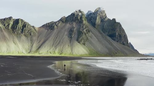Drone Of Man On Black Beach Under Vestrahorn Mountain