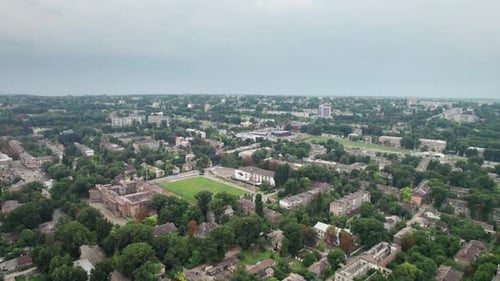 Aerial View of a Small Town Urban Landscape Flying By Houses Near Green Spaces