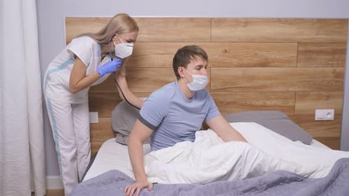 Healthcare Worker Examining Patient at Home