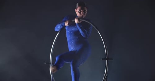 Acrobat Performs in Metal Hoop in Sparkling Bodysuit