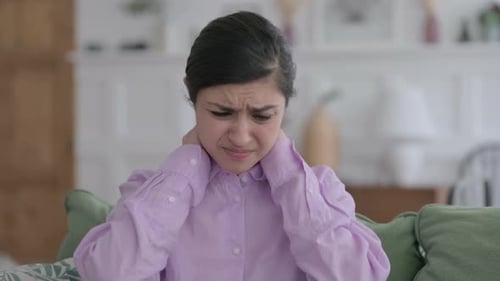 Young Woman with Neck Pain Rubbing Her Neck