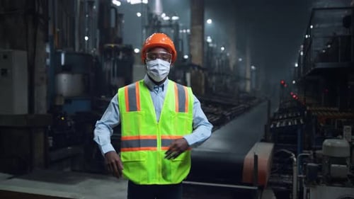 Factory Worker Wearing PPE in Industrial Setting
