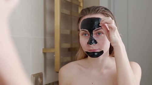 Beautiful Woman Removing Elastic Black Face Mask From Her Face
