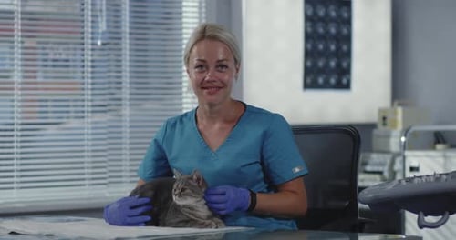 Woman Vet Smiling with Cat in Lap