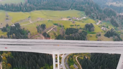 Aerial View of the Highway Viaduct on Concrete Pillars with Traffic in Mountains