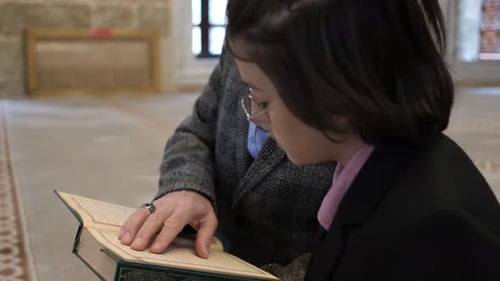 Child and Senior Man Reading Together