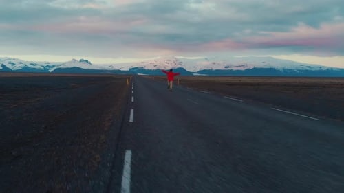 Man in red running on empty road