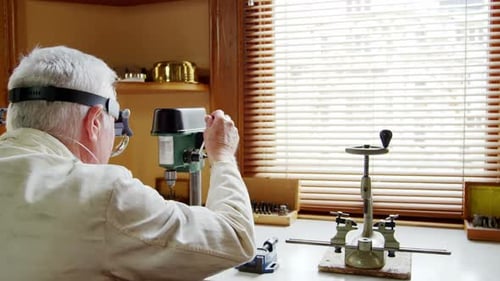Adult Male Using Small Drill Press on Workbench