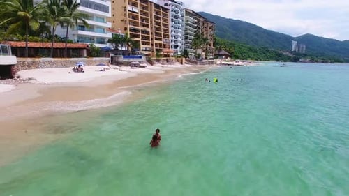 Aerial View of Tropical Beach with Swimmers