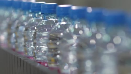 Bottles of Purified Water Move on Conveyor Belt