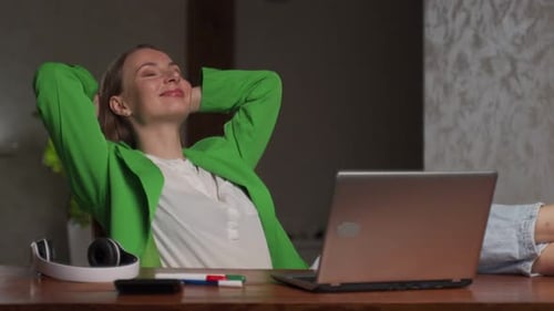 Woman Relaxing at Desk with Laptop