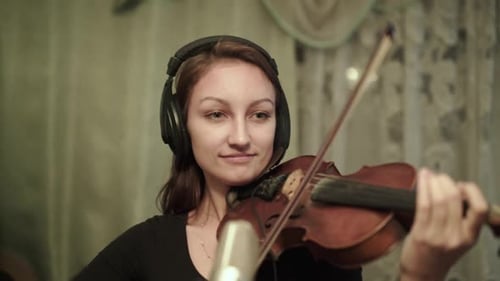 Woman Playing Violin in Home Music Studio