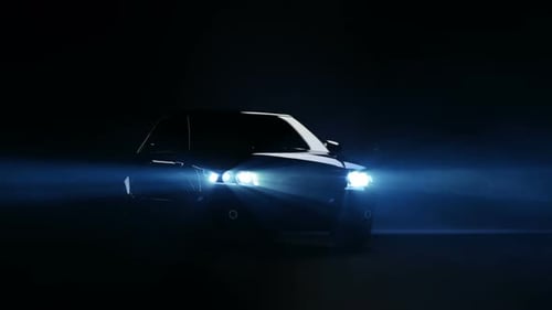 Sleek Car Reveal with Bright Headlights in Dark Fog