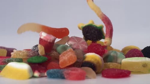 Vibrant Assortment of Gummy Candies Falling into Pile