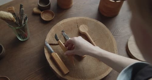 Close-up of Woman Carpenter's Hand Choosing Tools for Carving Wood