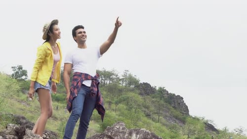 Happy group of friends walking in countryside in summer.