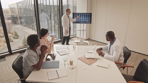 Medical Professionals Reviewing Brain Scan in Boardroom