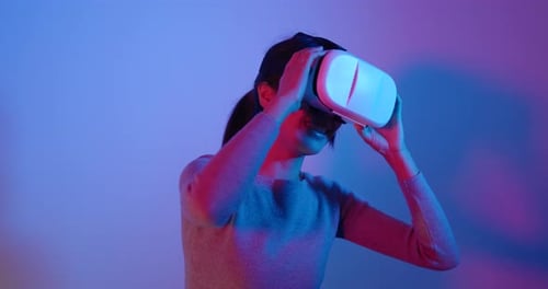 Woman Using Virtual Reality Headset Indoors