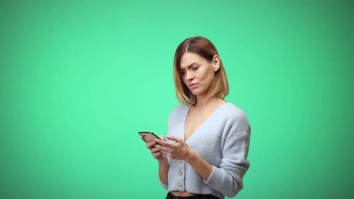 Woman Uses Mobile Phone on Green Screen Background