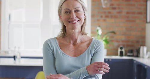 Smiling Mature Woman Posing in Bright Kitchen