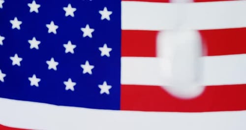 Military Dog Tags with American Flag in Background