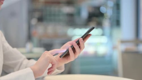 Side View of Female Hands Typing on Smartphone