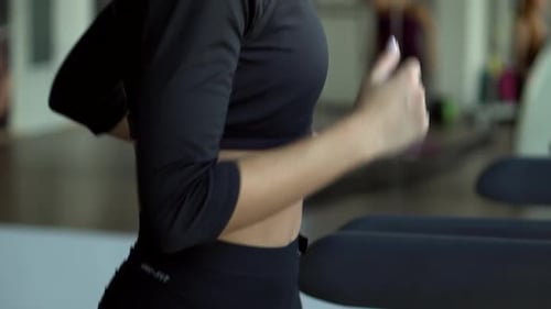 Young Woman Runs on a Treadmill in the Gym, Slow Motion