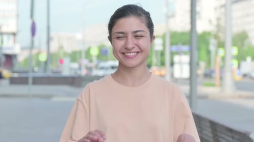 Smiling Woman Makes Heart Shape With Hands