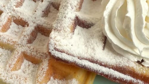 Waffles with Powdered Sugar and Whipped Cream
